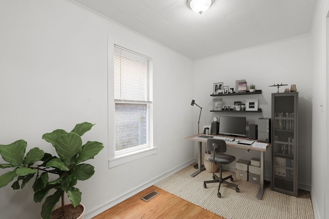 office area featuring crown molding and wood-type flooring