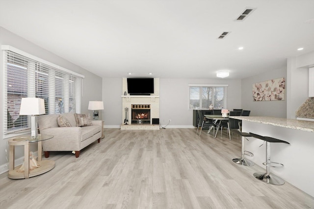 living room featuring a fireplace and light hardwood / wood-style floors