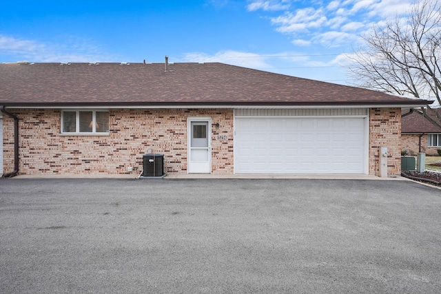 view of property exterior featuring central AC and a garage