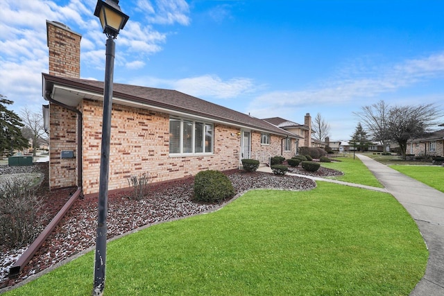 view of side of home with a yard