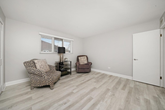 living area with light hardwood / wood-style flooring