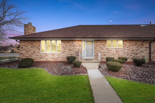 ranch-style house featuring a yard