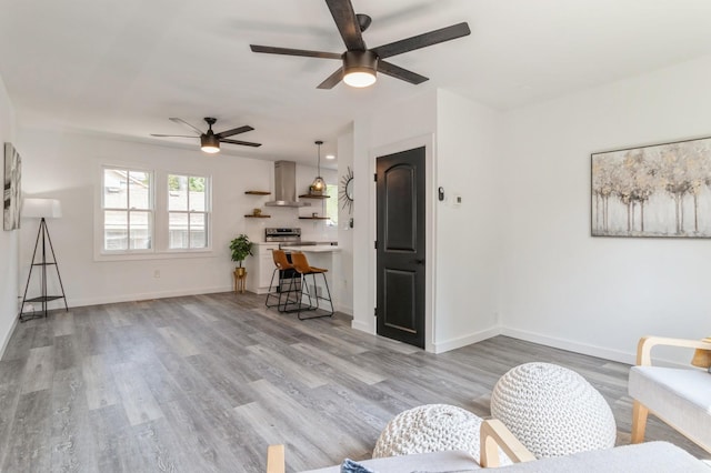 living room featuring ceiling fan and light wood-type flooring