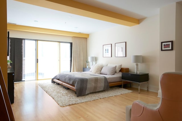 bedroom with access to exterior and light wood-type flooring