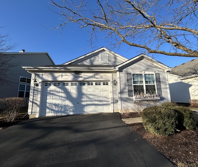 ranch-style home with a garage and driveway