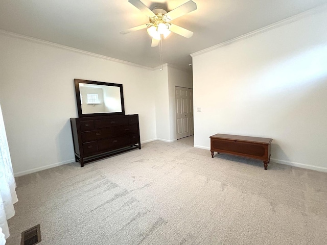 carpeted bedroom with visible vents, ceiling fan, crown molding, and baseboards