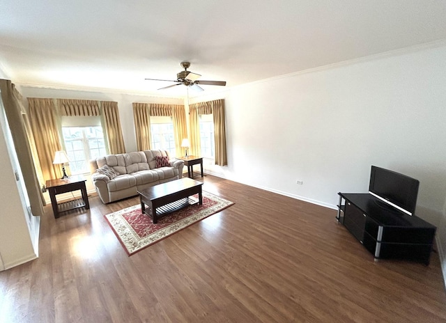 living room featuring dark wood finished floors, baseboards, crown molding, and a ceiling fan