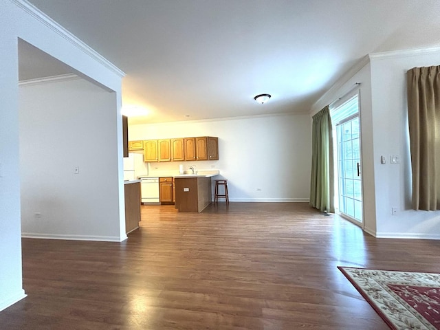 unfurnished living room featuring a sink, dark wood-style floors, baseboards, and ornamental molding