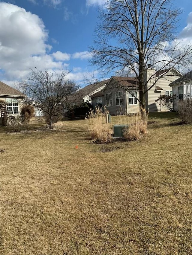 view of side of home featuring a lawn