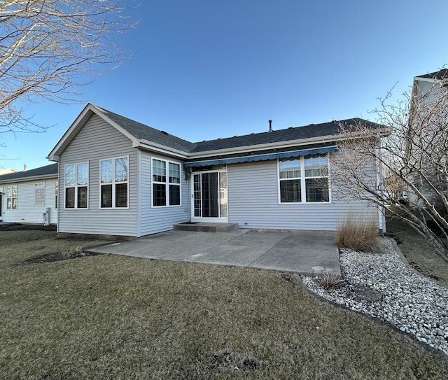 back of house featuring a patio and a lawn