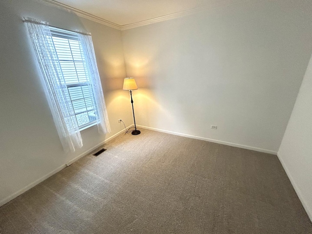 carpeted empty room featuring visible vents, baseboards, and ornamental molding