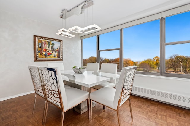 dining area with baseboard heating and parquet floors