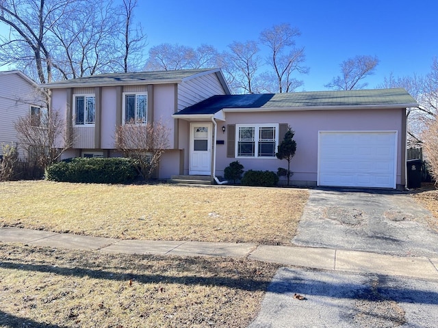 split level home with a front yard and a garage