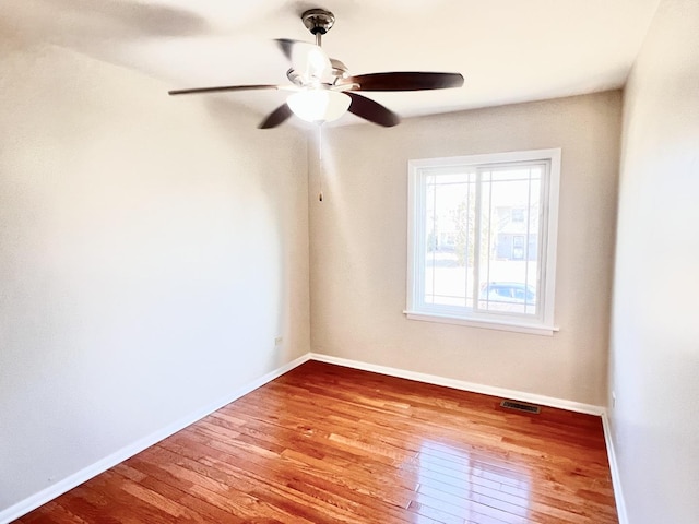 spare room with ceiling fan and light wood-type flooring