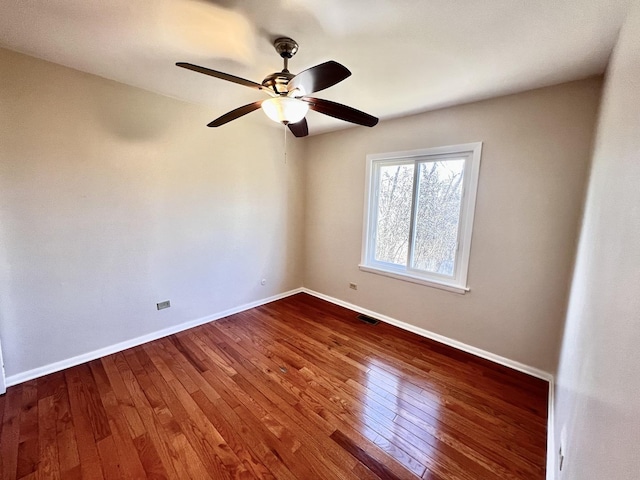 empty room with ceiling fan and wood-type flooring