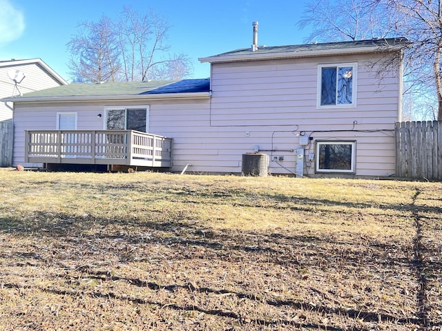 back of property with a deck, a yard, and central air condition unit