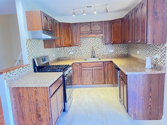 kitchen featuring decorative backsplash, sink, and appliances with stainless steel finishes