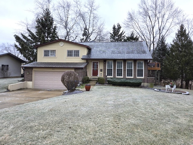 tri-level home featuring a garage and a front lawn