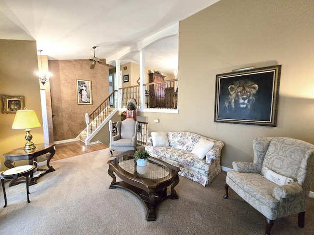 living room featuring ornate columns and lofted ceiling