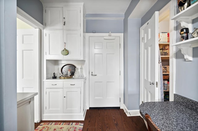 bar featuring white cabinets and dark wood-type flooring