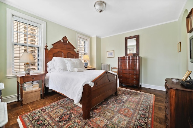 bedroom with radiator heating unit, dark parquet floors, and crown molding