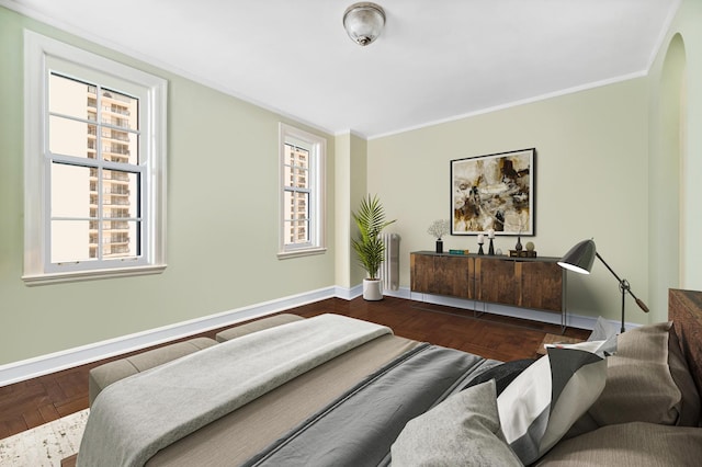 bedroom featuring multiple windows, parquet floors, and ornamental molding