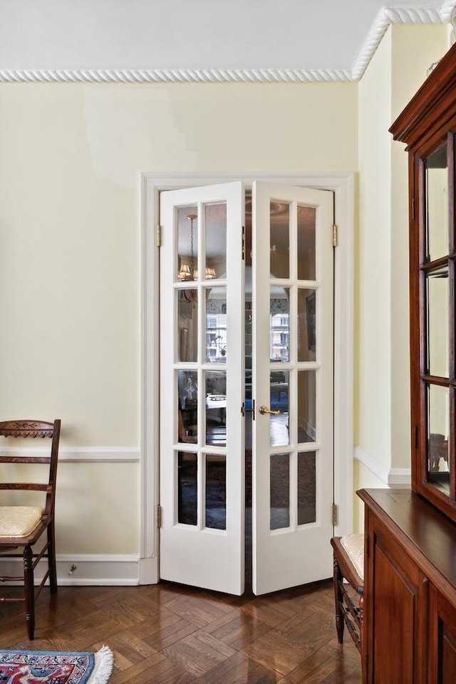 doorway with dark parquet flooring and french doors