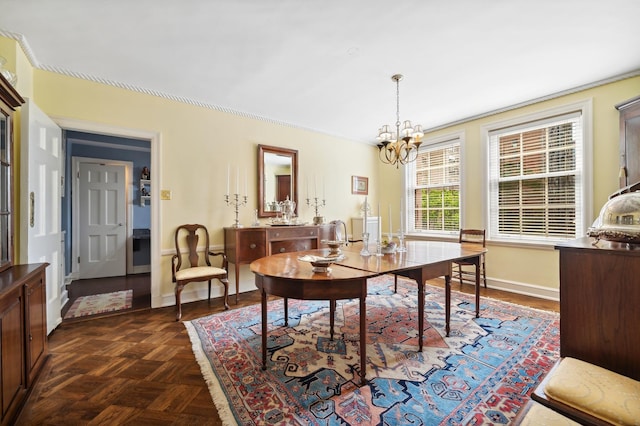 dining area featuring dark parquet floors and a notable chandelier