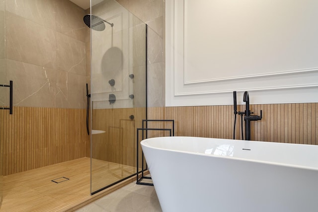 bathroom with tile patterned floors, independent shower and bath, and sink