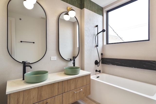 bathroom with vanity and a bath