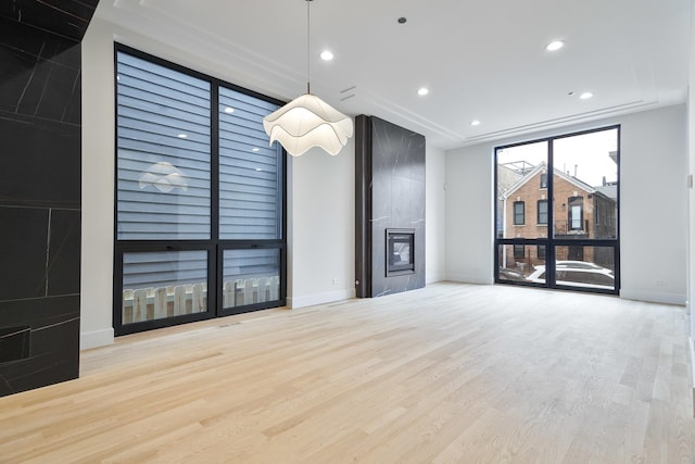 unfurnished living room featuring light hardwood / wood-style floors and a fireplace