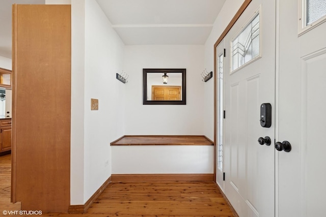 foyer featuring light wood-style flooring and baseboards