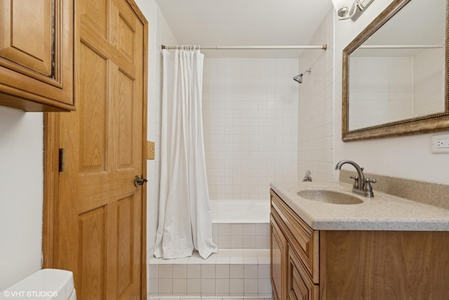 full bathroom with toilet, tiled shower / bath combo, and vanity