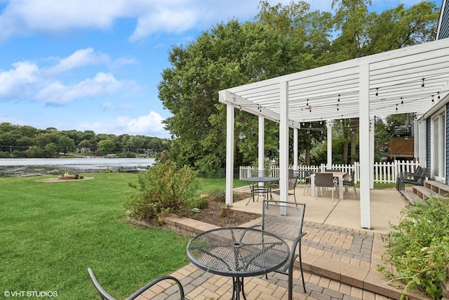 view of patio / terrace featuring a water view, fence, and a pergola