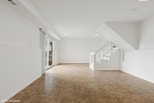 interior space featuring visible vents, stairway, and baseboards