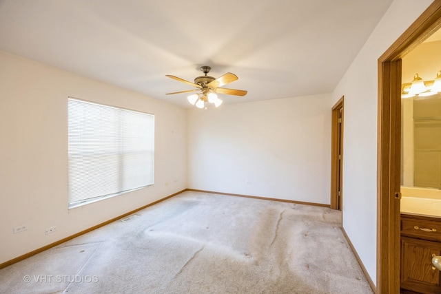 spare room with light carpet and ceiling fan