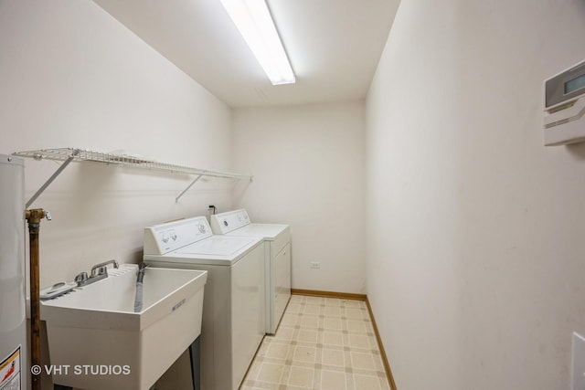 washroom featuring washer and clothes dryer, gas water heater, and sink