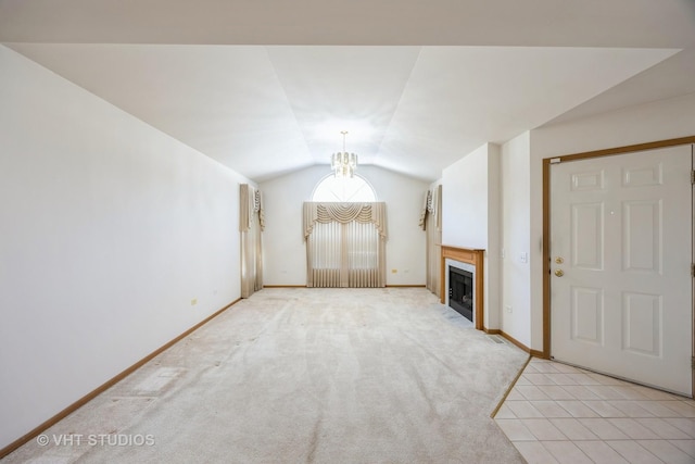 unfurnished living room with light carpet, lofted ceiling, and a notable chandelier