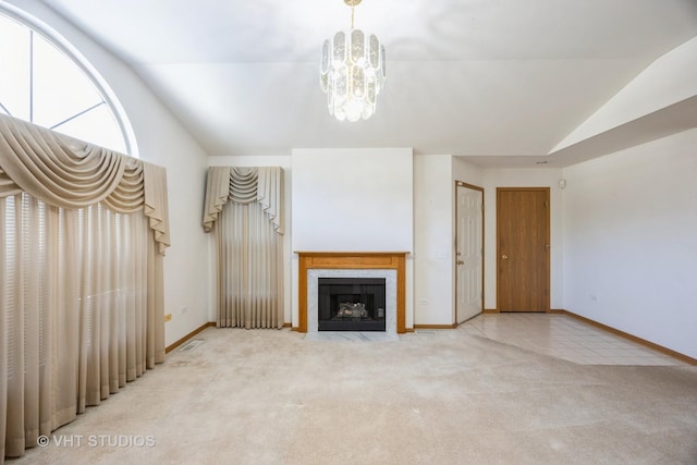 unfurnished living room with carpet, a notable chandelier, and lofted ceiling