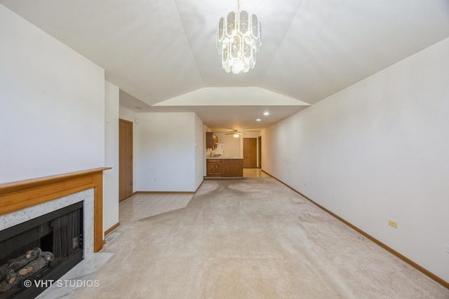 unfurnished living room featuring light carpet, ceiling fan with notable chandelier, and vaulted ceiling