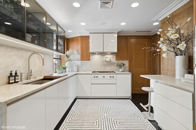1540 N Lake Shore Dr Unit 8N, Chicago, IL 60610 - kitchen with decorative backsplash, white cabinets, ornamental molding, recessed lighting, and glass insert cabinets