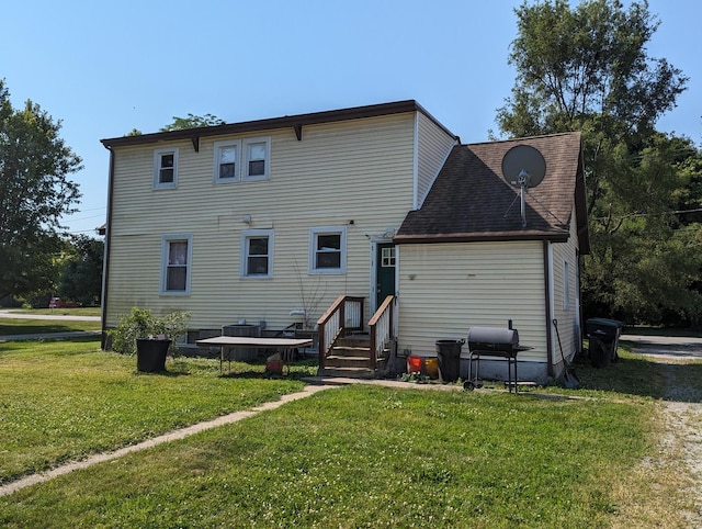 rear view of property with a yard