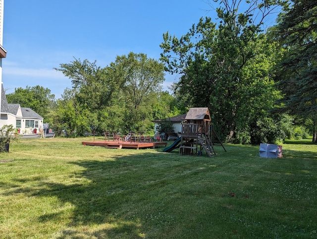 view of yard featuring a playground and a deck