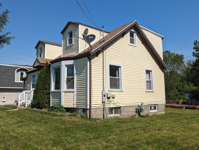 rear view of property with a yard