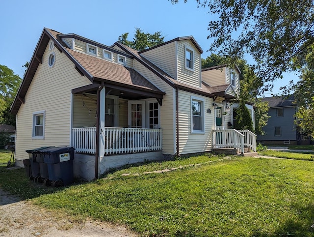 view of front of house with a porch and a front lawn