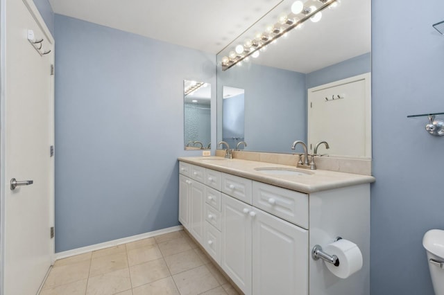 bathroom with tile patterned floors, vanity, and toilet