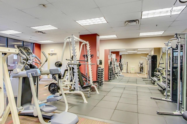 exercise room with a paneled ceiling