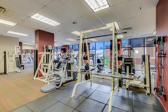 gym featuring a paneled ceiling