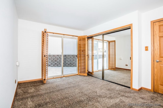 unfurnished bedroom featuring carpet floors and a closet