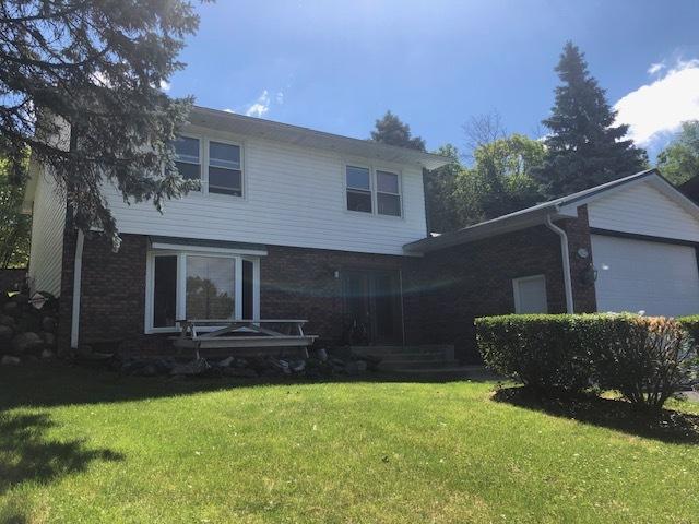 view of front of home with a front yard and a garage